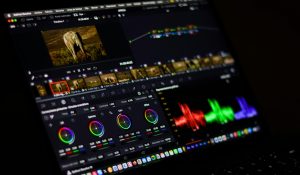 Close-up view of professional video editing software displaying colorful waveforms.