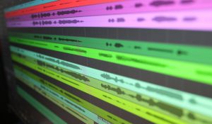 Close-up of audio waveforms on screen, showcasing music production software in use.